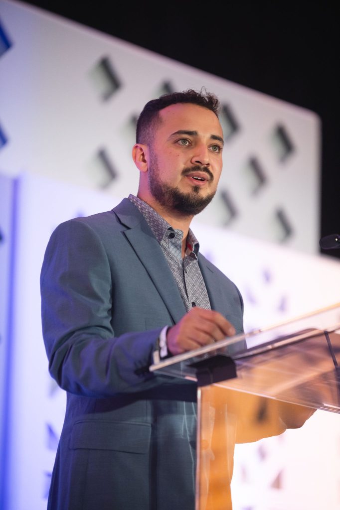 DSF Alum Diego Burciaga speaking at the podium