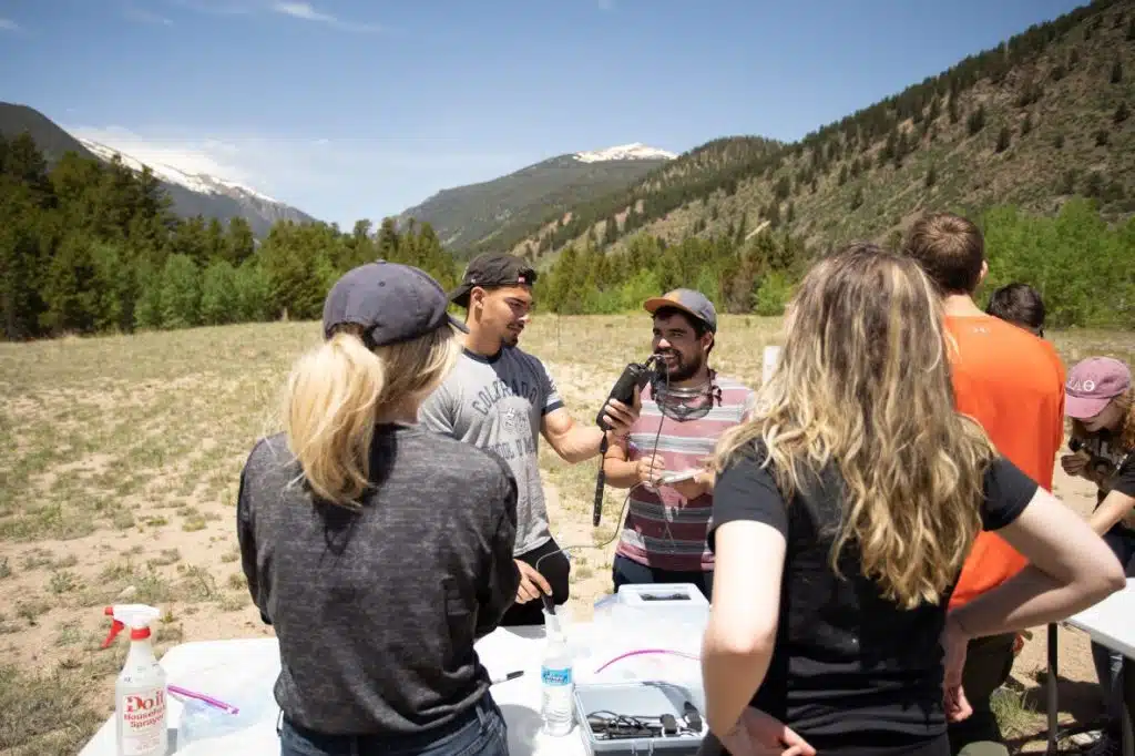 Luis and other students in an outdoor science lab