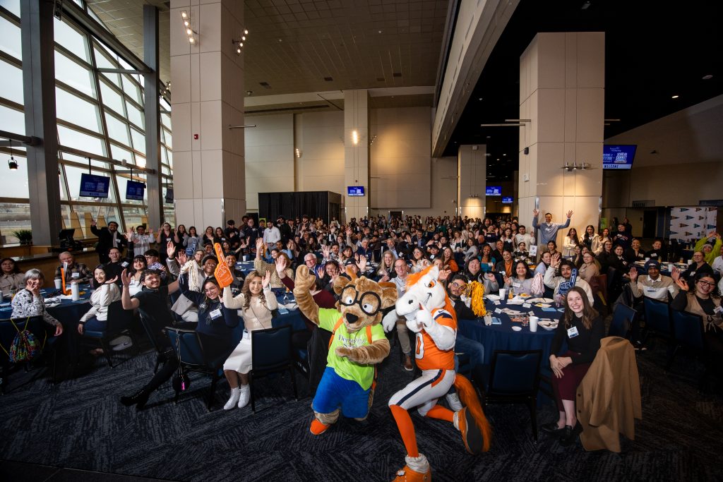 Large group of DSF scholars, alumni, and community members seated in the 10th‑annual Gathering of Gratitude breakfast at Empower Field at Mile High.