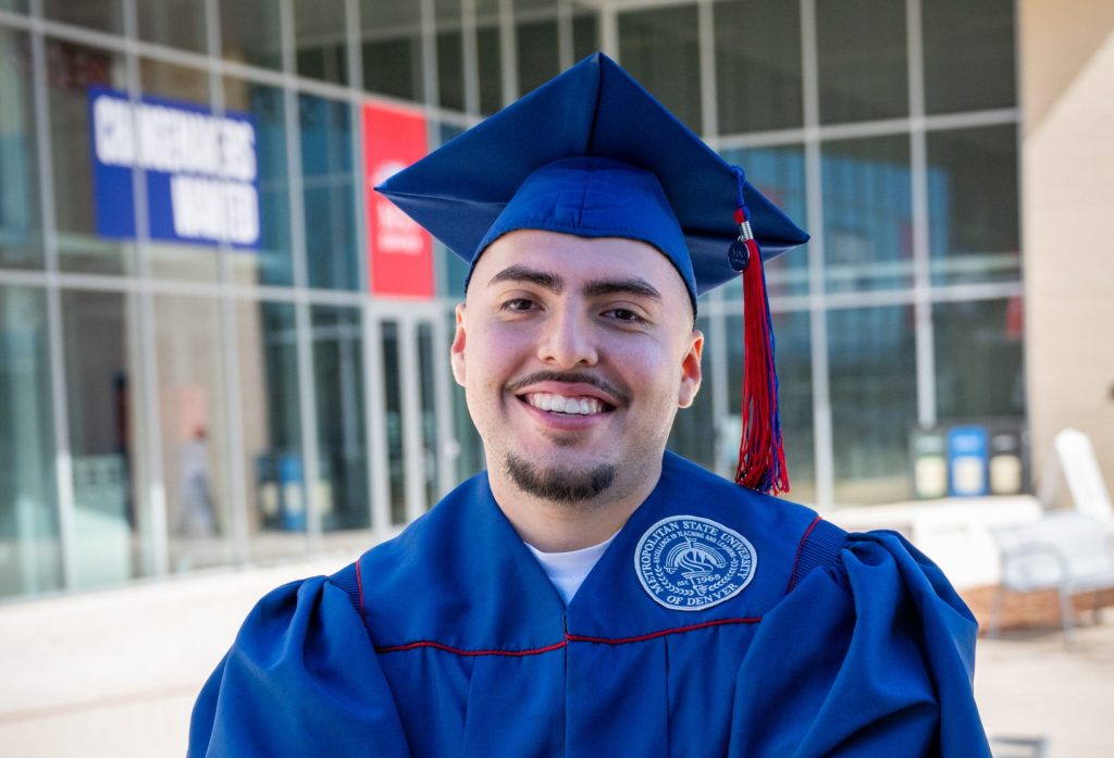 DSF Alum Campos standing in front of MSU Denver's Jordan Student Success Building