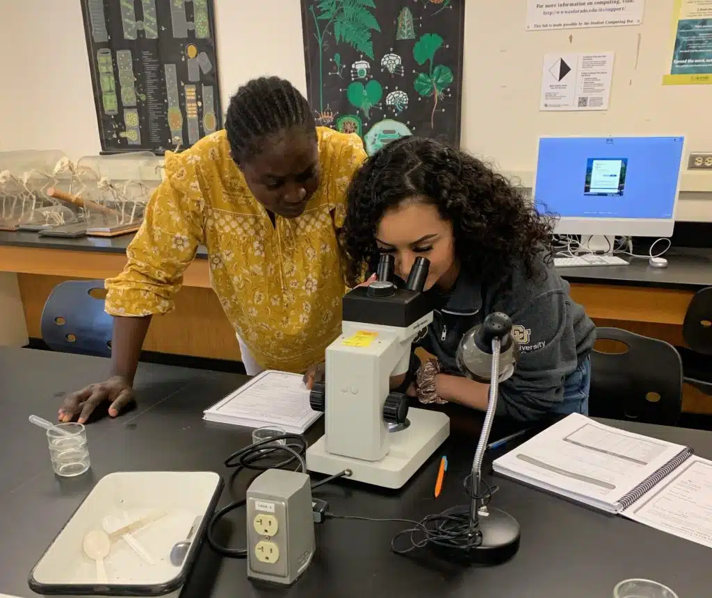 Deysi at CU Boulder lab as she works with lab equipment