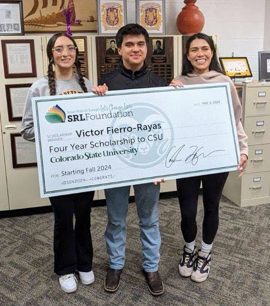 DSF College Advisors Zulema Sierra, Victor Fierro-Rayas, and Michele Lopez are posing with a check when he received a scholarship. 