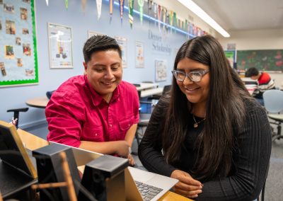 DSF College Advisor in a pink shirt helps DPS student with applications to college in the DSF Future Center