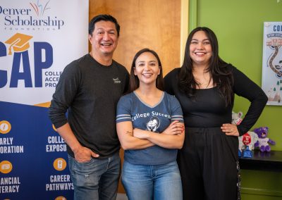 DSF College Advisors pose in front of a sign for the College Access Program in the DSF Future Center at Lincoln High School