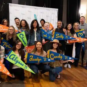 DSF Staff holding pennants representing the year they started at DSF
