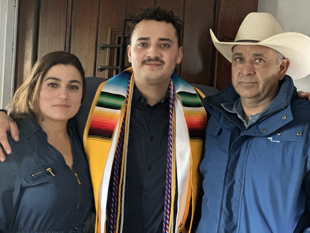 Diego with his parents at after his graduation ceremony at CU Denver