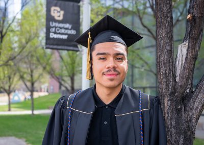 DSF Scholar Christian in front of CU Denver flag