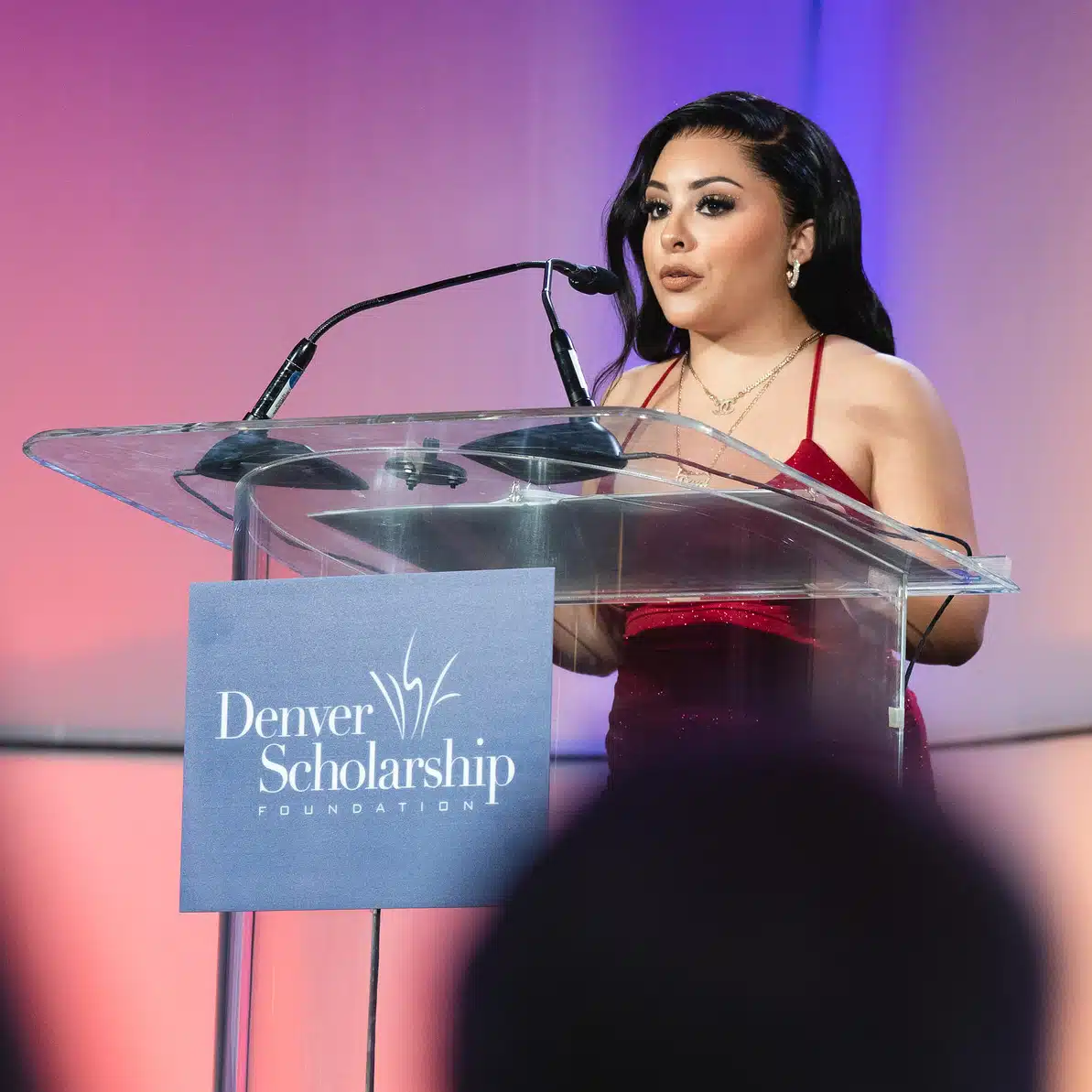 Deysi Macias speaking at a podium at the DSF Gala