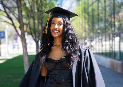 DSF Scholar Kanani in front of a building and trees on Auraria Campus