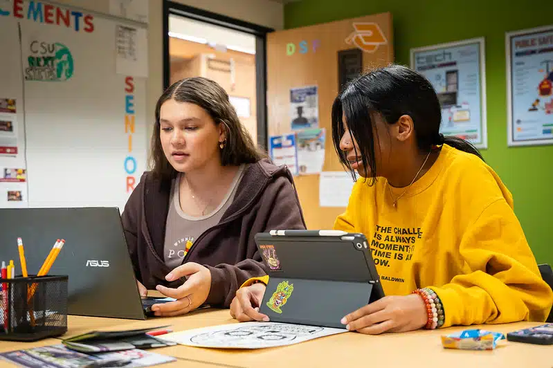 Two student at a DSF Future Center filling out financial aid applications